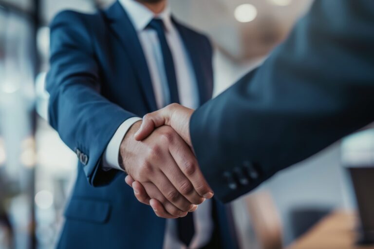 Businessman handshakes greeting say hello to other in office meeting client customer business partner | Houlihan Capital Shaking hands on an employee-owned valuation firm