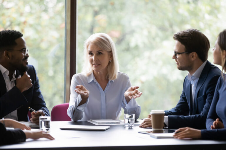 Mature leader boss give helpful information to young diverse professionals | Houlihan Capital